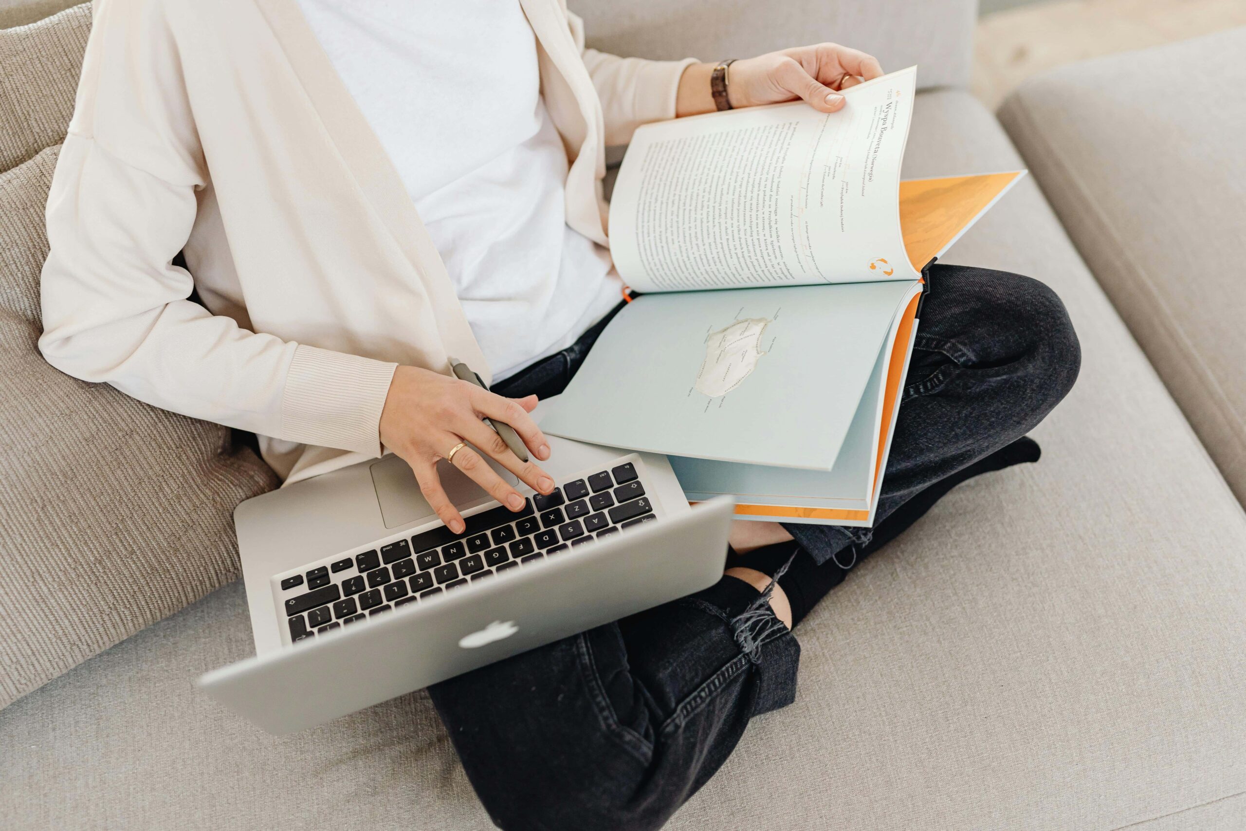 Image of books and laptop being simultaneously read.