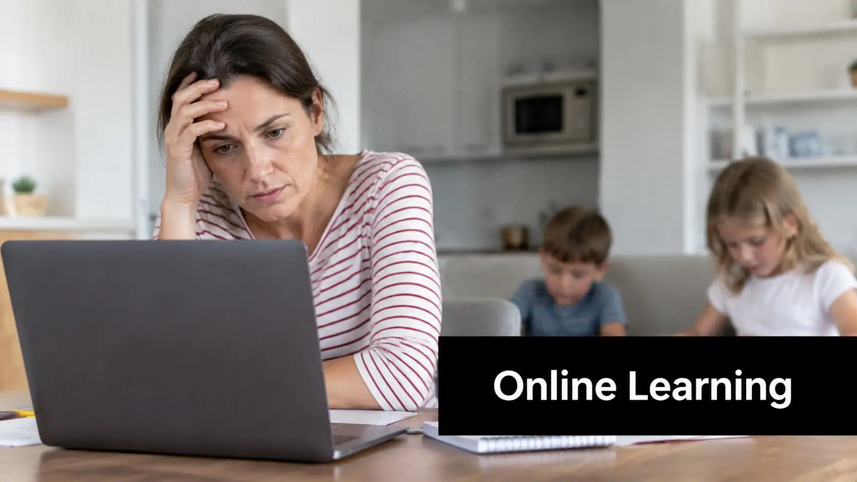 A stressed woman working on a laptop at home while her children do schoolwork in the background.
